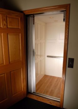 Home Elevator with Executive raised panel car in white with hardwood floor