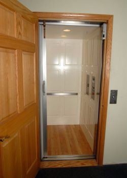 Home Elevator with white Executive raised panel car and stainless car operating station
