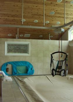 Ceiling track lift system - over therapy pool with lifting sling